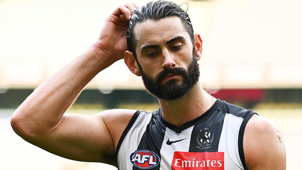 Brodie Grundy looks down as he walks from the field.