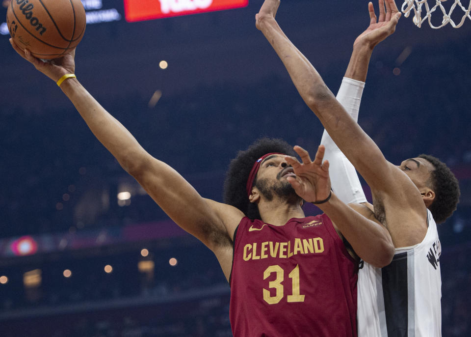 Cleveland Cavaliers' Jarrett Allen (31) shoots over San Antonio Spurs' Victor Wembanyama (1) during the first half of an NBA basketball game in Cleveland, Sunday, Jan. 7, 2024. (AP Photo/Phil Long)