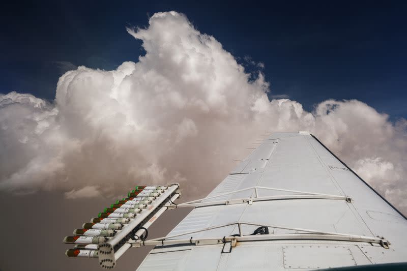 Hygroscopic flares are attached to an aircraft during a cloud seeding flight in United Arab Emirates