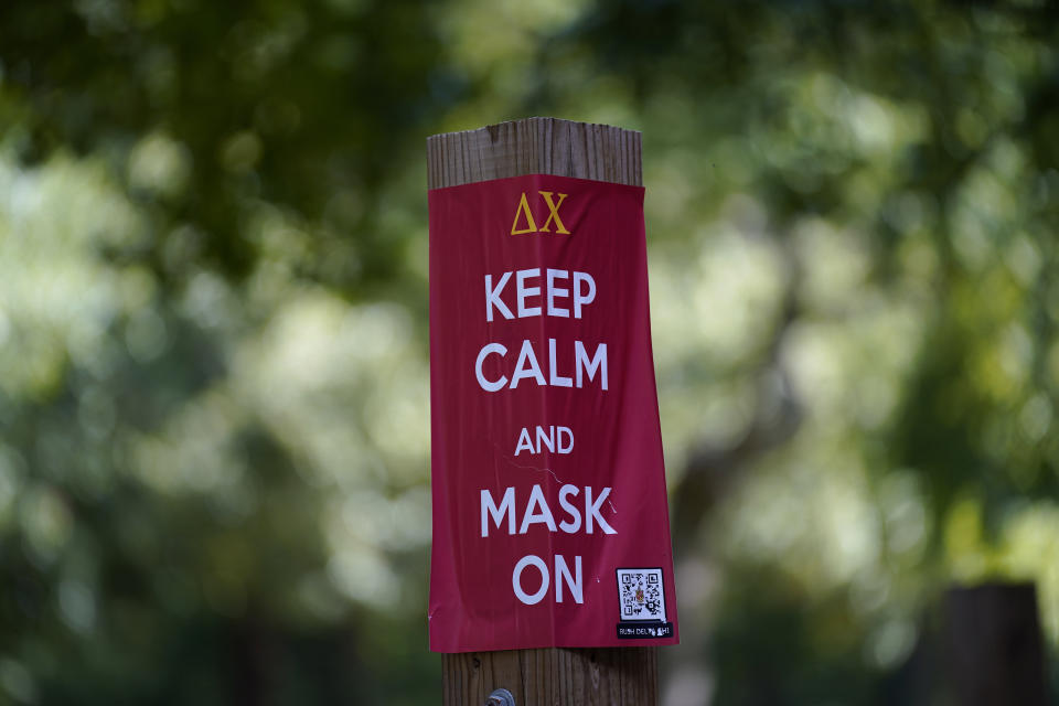 A sign is posted outside Hinton James dormitory at the University of North Carolina in Chapel Hill, N.C., Tuesday, Aug. 18, 2020. The university announced that it would cancel all in-person undergraduate learning starting on Wednesday following a cluster of COVID-19 cases on campus. (AP Photo/Gerry Broome)