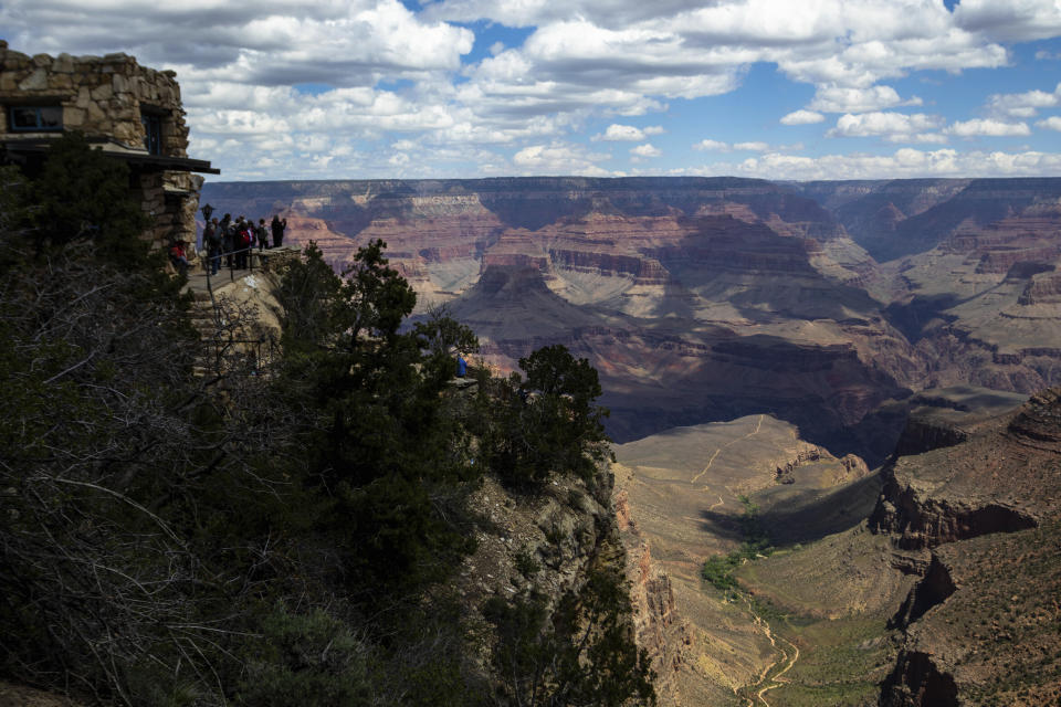 Tourists look out from the South Rim at the Grand Canyon on Thursday, May 4, 2023. The Havasupai Tribe held a blessing ceremony to mark the renaming of a popular campground from Indian Garden to Havasupai Gardens. (AP Photo/Ty O'Neil)