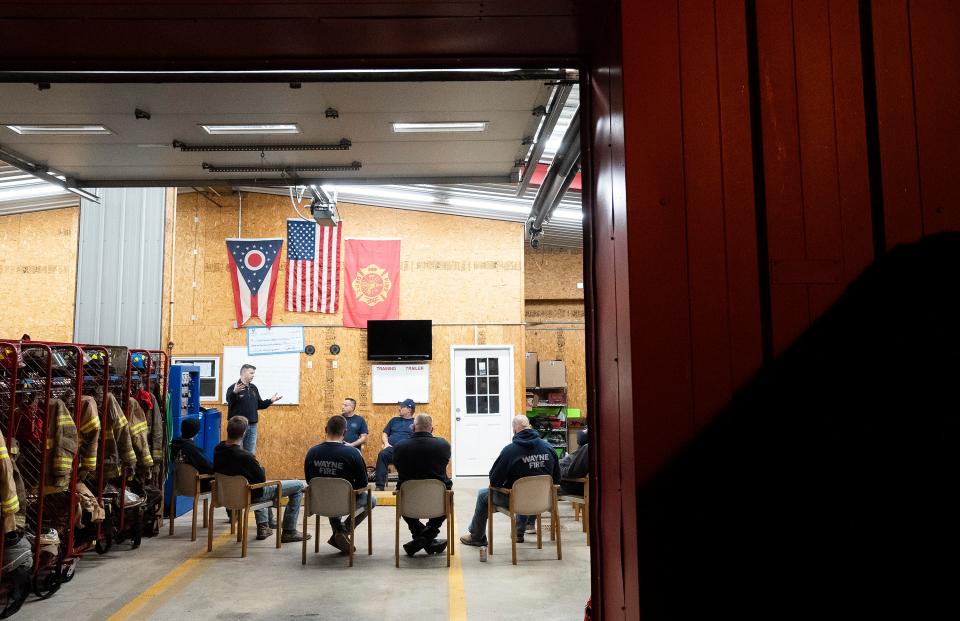 Volunteer firefighters gather for a meeting at the Wayne Township Fire Department in Good Hope, Ohio.