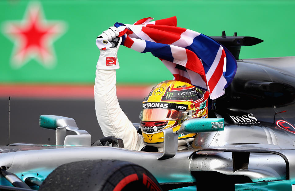 Lewis Hamilton celebrates a fourth world title