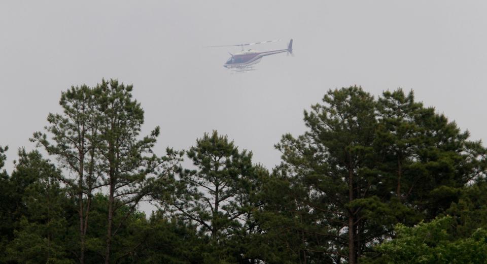 An observation helicopter flys above a brush fire off Cedar Swamp Road in Jackson Township Tuesday evening, June 6, 2023.