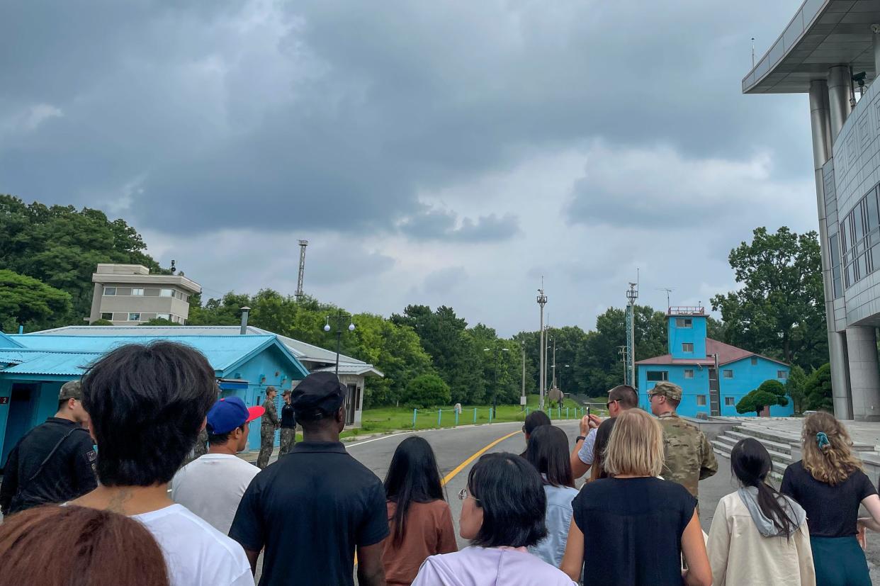 A group of tourists stand near a border station at Panmunjom in the Demilitarized Zone in Paju, South Korea, on July 18. Not long after this photo was taken, Travis King, a U.S. soldier, bolted across the border and became the first known American detained in the North in nearly five years.