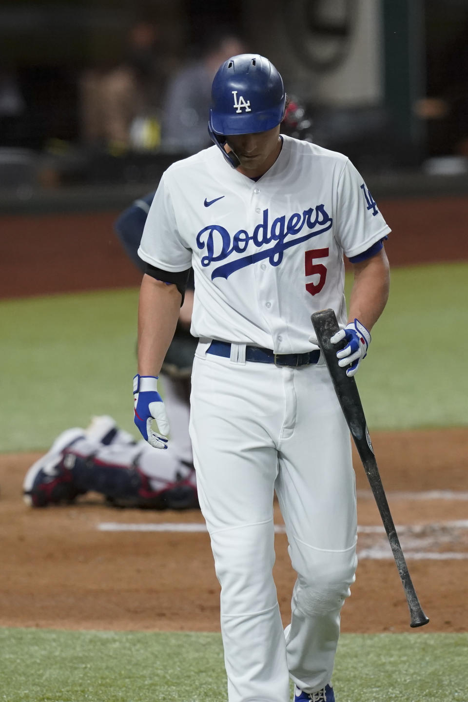 Los Angeles Dodgers' Corey Seager walks the dugout after starting out against the Atlanta Braves during the first inning in Game 1 of a baseball National League Championship Series Monday, Oct. 12, 2020, in Arlington, Texas. (AP Photo/Eric Gay)