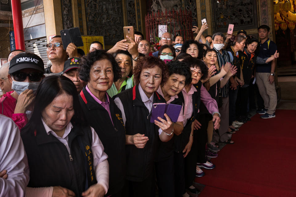 Supporters wait for photo opportunities outside a temple on Oct. 4. | Billy H.C. Kwok for TIME