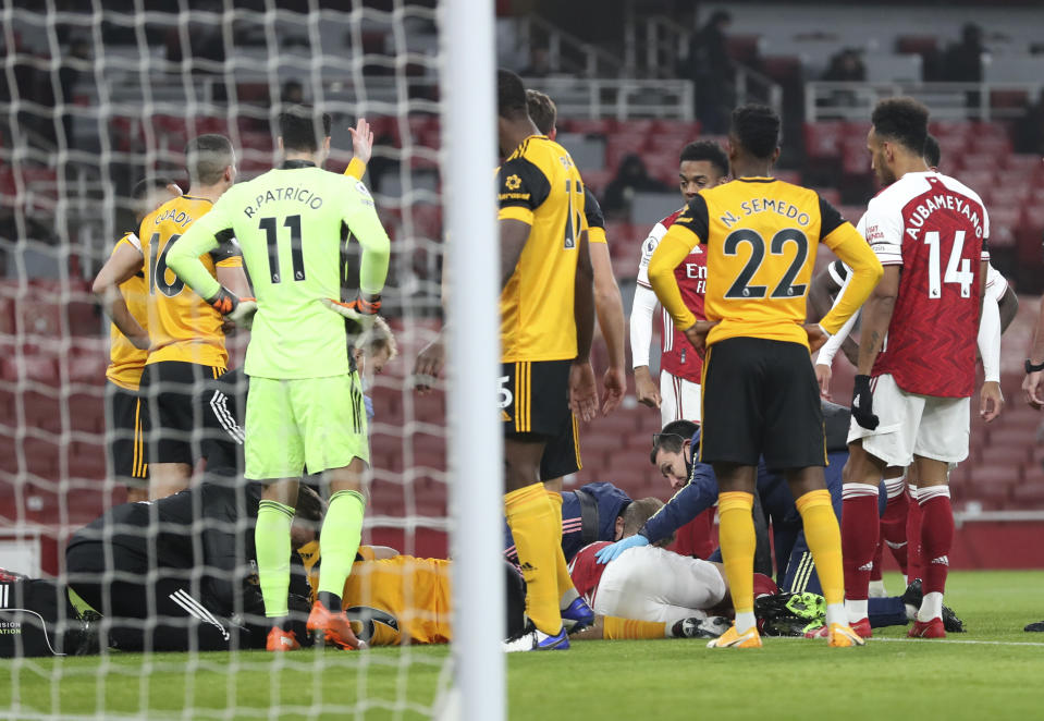 Wolverhampton Wanderers' Raul Jimenez and Arsenal's David Luiz are checked by medical staff following ahead clash during the English Premier League soccer match between Arsenal and Wolverhampton Wanderers at Emirates Stadium, London, Sunday, Nov. 29, 2020. (Catherine Ivill/Pool via AP)