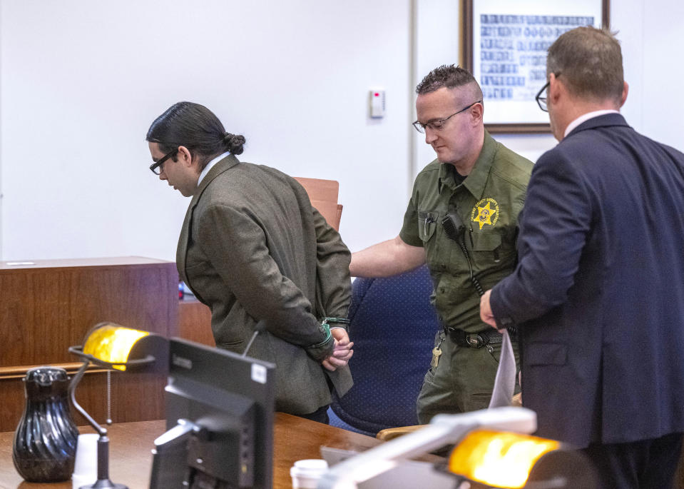 Marcus Eriz, left, is led away after his sentencing, Friday, April 12, 2024, in Santa Ana, Calif. Eriz was sentenced Friday to 40 years to life for the fatal shooting of a 6-year-old boy who was riding in the back of his mother's car on the freeway, prosecutors said. (Mark Rightmire/The Orange County Register via AP)