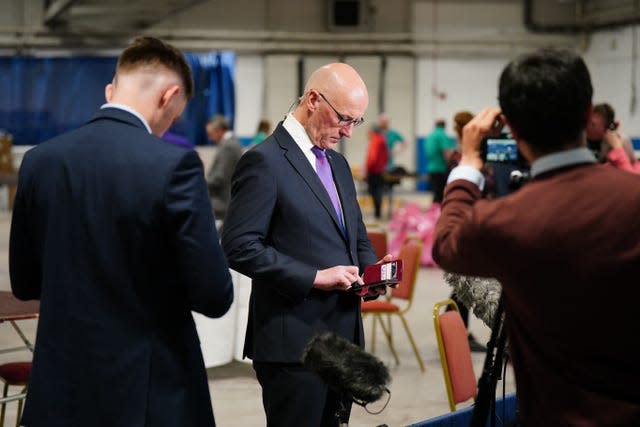 Scottish First Minister and SNP leader John Swinney looks at his phone at Ice Hall in the Dewars Centre, Perth, during the count 