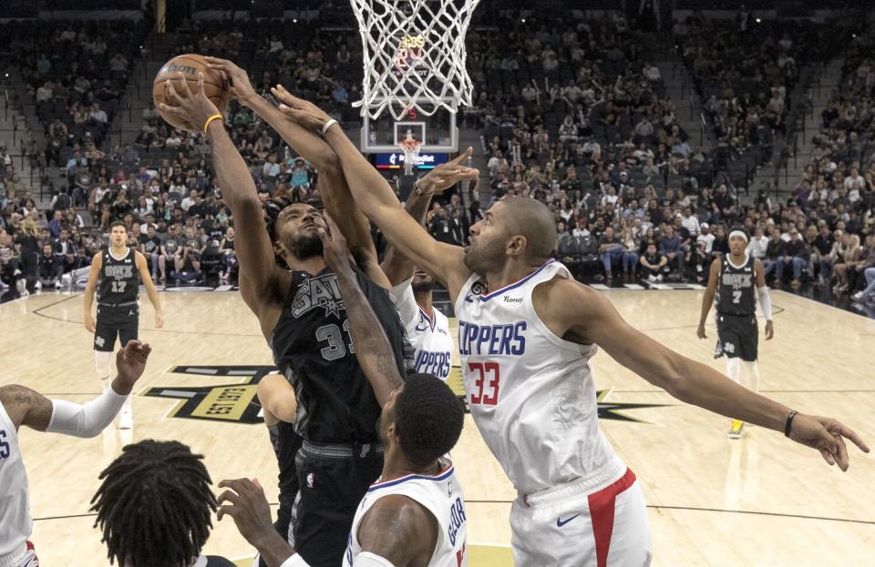 Los Angeles Clippers forward Nicolas Batum contests a shot by San Antonio Spurs forward Keita Bates-Diop