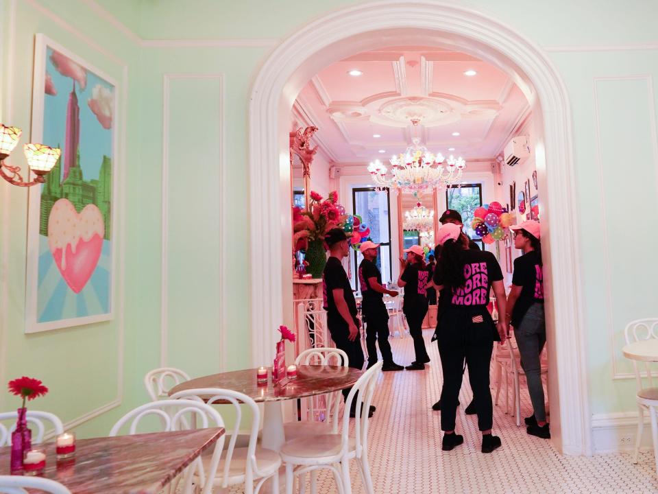 Inside Serendipity 3 with an archway full of staff members on the right