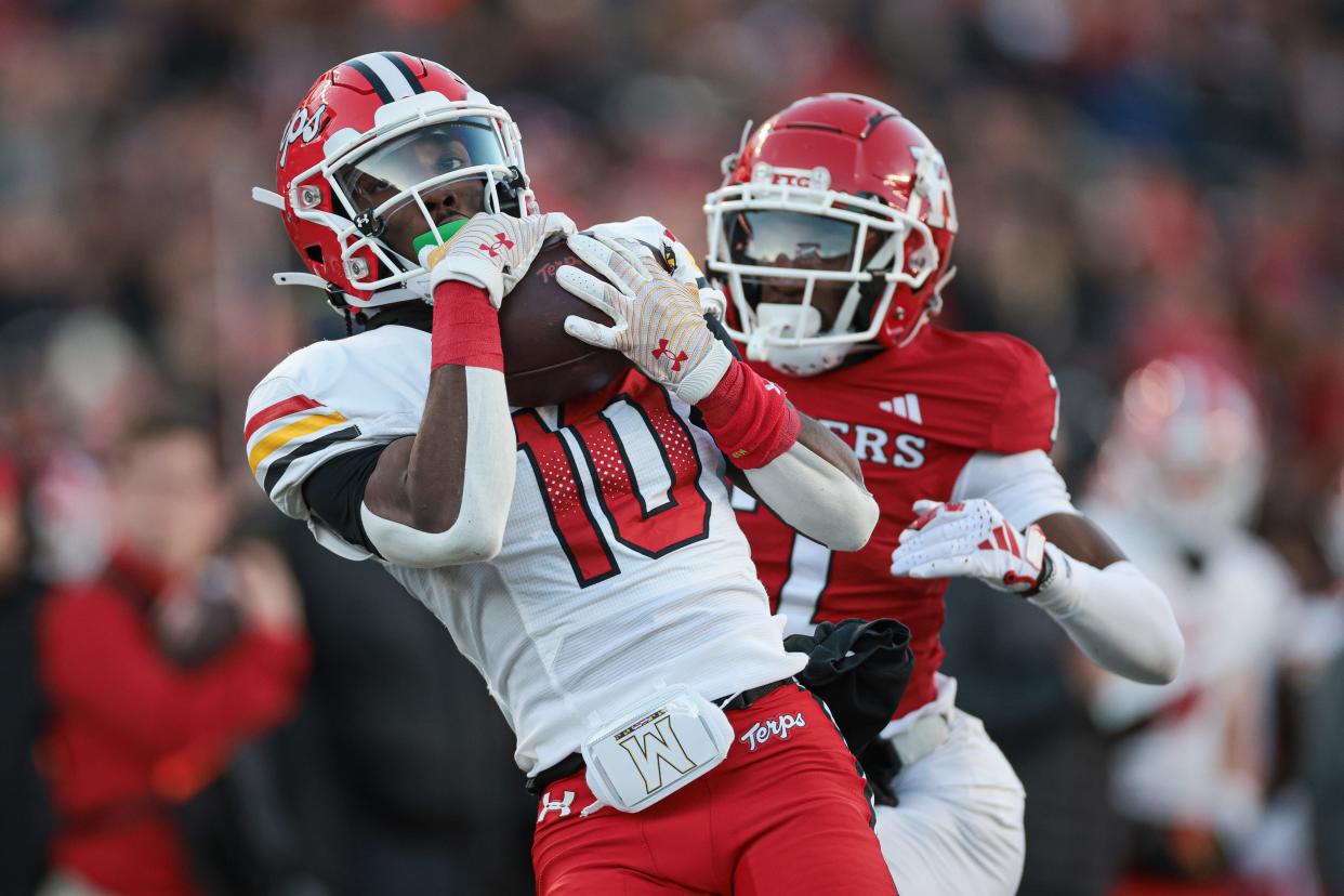 Nov 25, 2023; Piscataway, New Jersey, USA; Maryland Terrapins wide receiver Tai Felton (10) catches a touchdown pass as Rutgers Scarlet Knights defensive back Robert Longerbeam (7) defends during the first half at SHI Stadium. Mandatory Credit: Vincent Carchietta-USA TODAY Sports