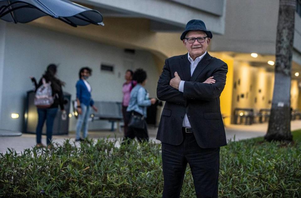 Students pass by as Mark Rosenberg, now former president of Florida International University, stands in front of the Steven and Dorothea Green Library at the FIU Modesto Maidique Campus off Southwest Eighth Street and 107th Avenue.