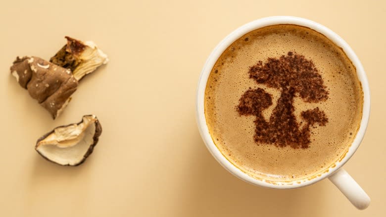 Top-down view of a mug of mushroom coffee next to mushroom pieces