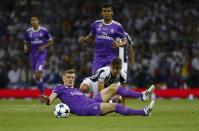 <p>Real Madrid’s Toni Kroos in action with Juventus’ Paulo Dybala </p>
