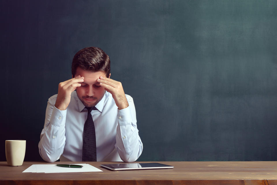 Stressed teacher at his desk