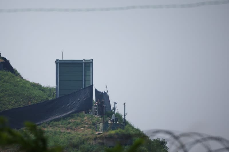 South Korean soldiers work next to a military facility where loudspeakers dismantled in 2018 used to be, near the demilitarized zone separating the two Koreas in Paju