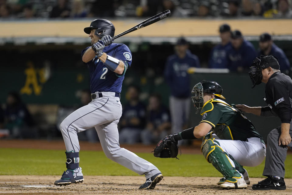 Seattle Mariners' Tom Murphy hits an RBI-single in front of Oakland Athletics catcher Sean Murphy during the fourth inning of a baseball game in Oakland, Calif., Wednesday, Sept. 22, 2021. (AP Photo/Jeff Chiu)