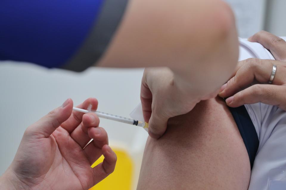 A healthcare worker from the National Centre for Infectious Diseases receiving a dose of the Pfizer- BioNTech COVID-19 vaccine on 30 December 2020. (PHOTO: MCI)