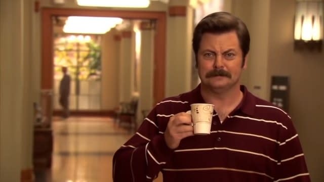 Ron with a coffee mug in "Parks and Recreation"