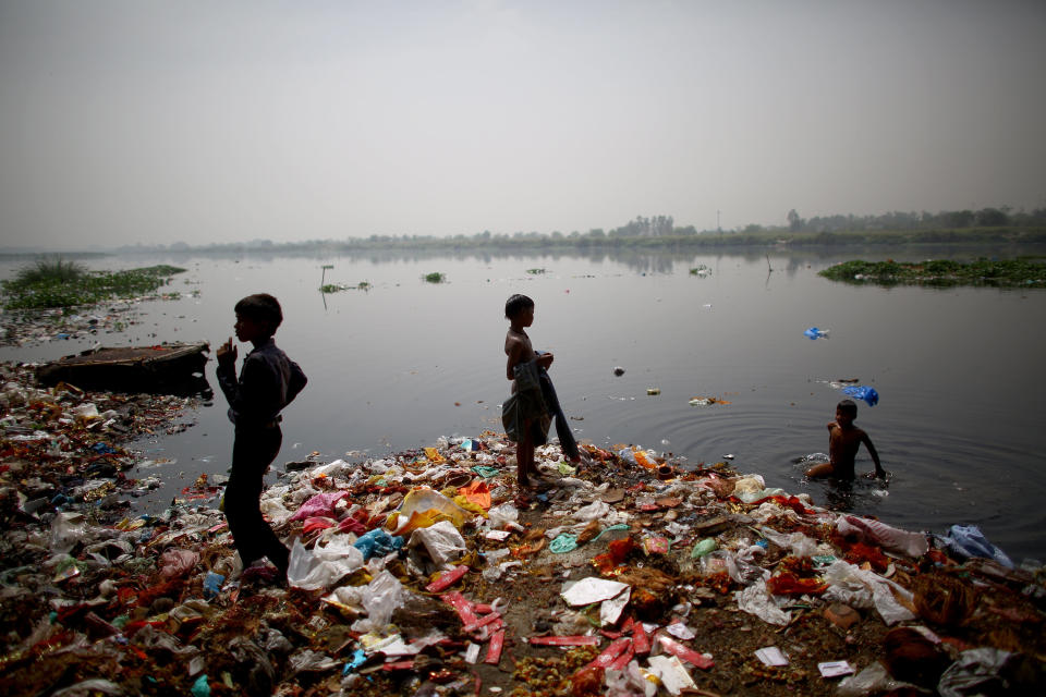 Children who live along the banks of India's Yamuna River in ramshackle huts hunt for coins and anything valuable they can collect. The waters are polluted with heavy metals, raw sewage and industrial waste, but they are also a lifeline for scavenging families.