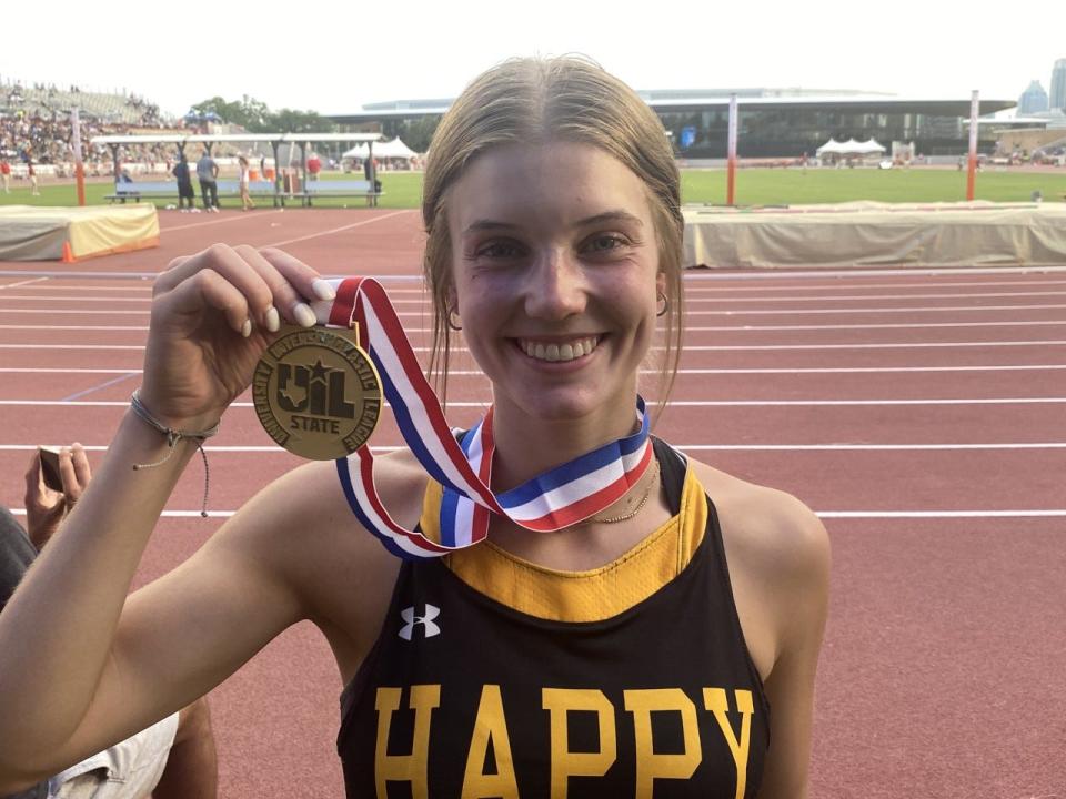 Happy senior Emily Berry poses with her 1A girls 400 gold medal.