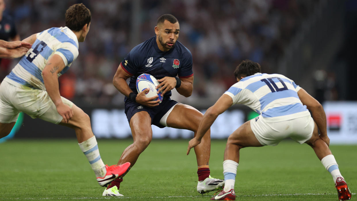  England's Joe Marchant faces down two Argentinian players in the teams' first Rugby World Cup game. 