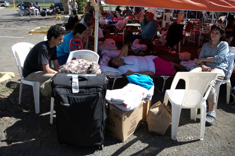 People rest at a temporary shelter camp in a sports complex, after an earthquake in Guanica