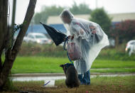 <p>A man and his dog pack up their belongings from the neutral ground on Poland Ave. as they take shelter from the first wave of rain to hit New Orleans as Tropical Storm Cindy heads toward Louisiana on Tuesday, June 20, 2017. (Photo: Chris Granger/NOLA.com The Times-Picayune via AP) </p>