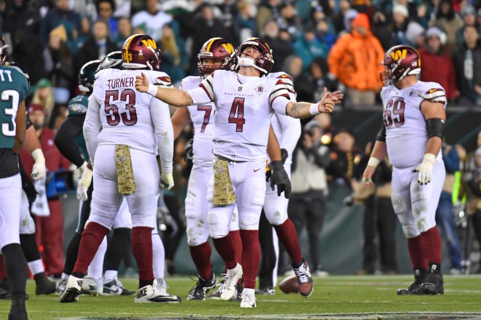 Washington Commanders quarterback Taylor Heinicke celebrates a penalty against the Philadelphia Eagles during the fourth quarter at Lincoln Financial Field.