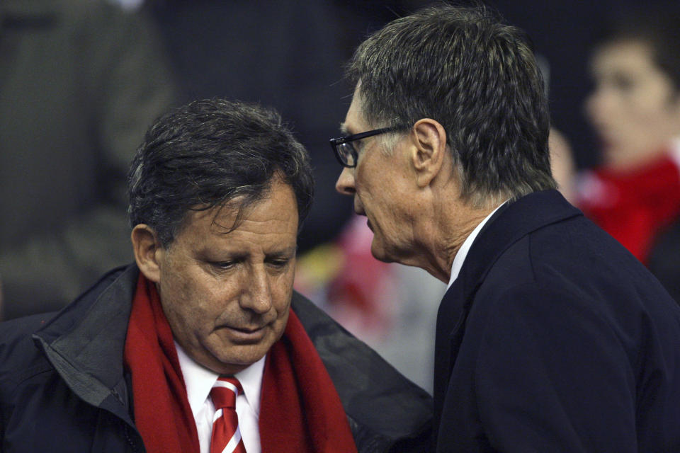 FILE - In this Jan. 25, 2012, file photo, Liverpool owners John Henry, right, and Tom Werner speak before their side's English League Cup semifinal second leg soccer match against Manchester City at Anfield Stadium in Liverpool, England. Liverpool won its first league title since 1990, clinching Thursday, June, 25, 2020. Because of the pandemic, Henry and Werner, who headed the group that bought the team in 2010, watched on television from the U.S. (AP Photo/Tim Hales, File)