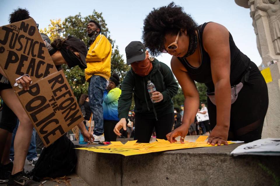 Meg White, right, of Sacramento, helps facilitate adding ideas for prison reform to a list as protesters continued rallying against police brutality and racial injustice into the evening at Cesar E. Chavez Plaza on Friday, June 5, 2020, in Sacramento.