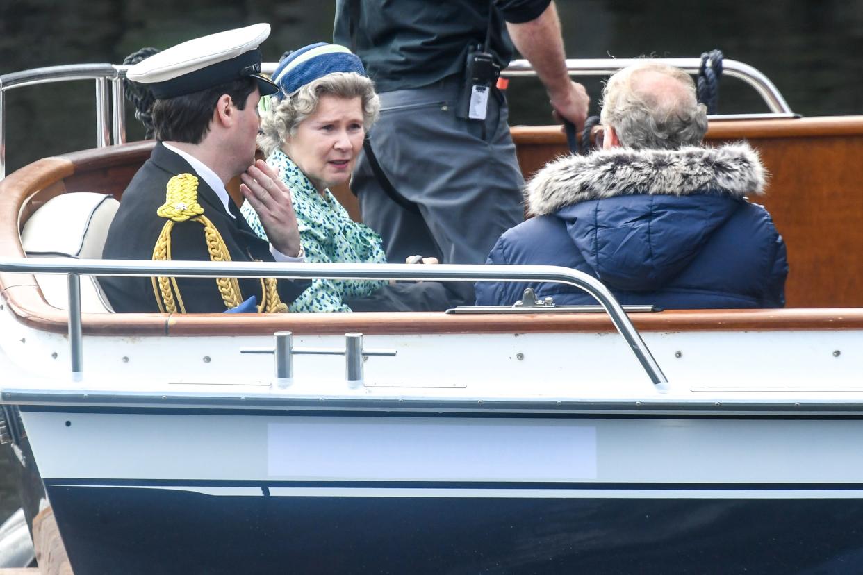 Imelda Staunton and other cast members are seen on a boat made to look like a royal yacht tender in the harbor during filming for the Netflix series "The Crown" on Aug. 2, 2021, in Macduff, Scotland.