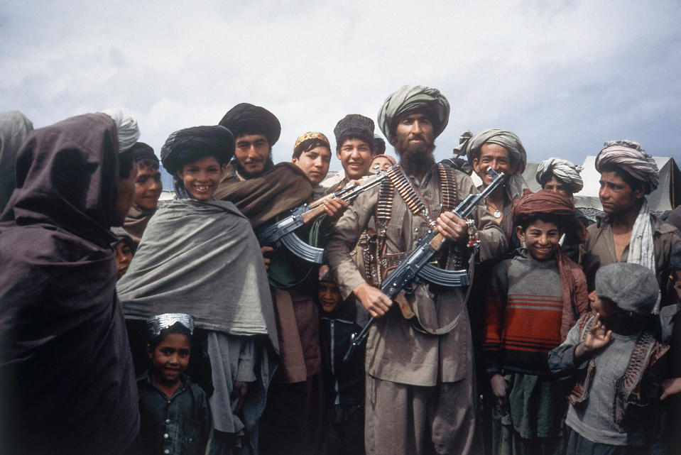 FILE - This file photo taken on April 1, 1984 shows Mujahedeen tribesmen at border camp near Wana in Afghanistan. Afghanistan is marking the 31st anniversary of the Soviet Union's last soldier leaving the country, Saturday, Feb. 15, 2020. This year's anniversary comes as the United States negotiates its own exit after 18 years of war, America's longest. (AP Photo/Christopher Gunness, File)
