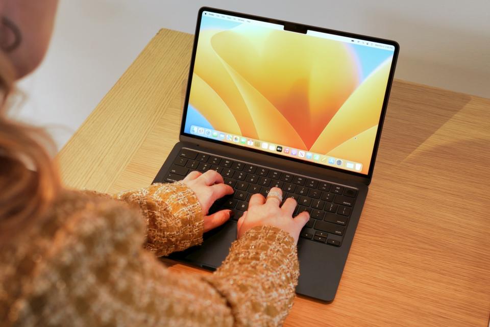 Woman typing on Apple MacBook Air 2 with M2 chip