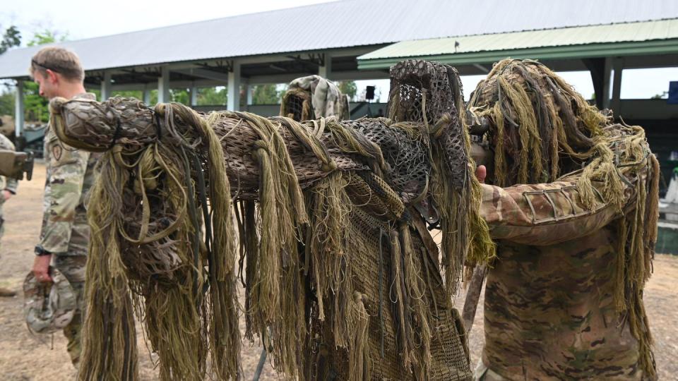 A U.S. soldier in sniper camouflage takes position at an static display of equipment during a U.S.-Philippines military exercise at Fort Magsaysay in Nueva Ecija province, north of Manila, on April 13, 2023. (Ted Aljibe/AFP via Getty Images)