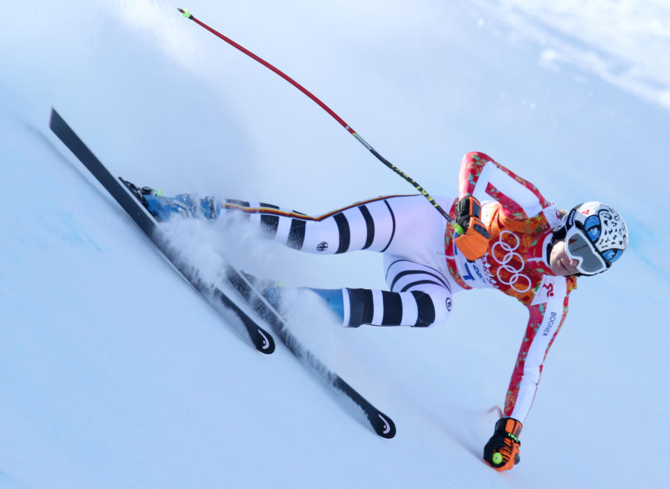 Germany's Maria Hoefl-Riesch makes a turn in a women's downhill training run for the Sochi 2014 Winter Olympics, Friday, Feb. 7, 2014, in Krasnaya Polyana, Russia. (AP Photo/Alessandro Trovati)