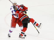 NEWARK, NJ - MAY 21: Stu Bickel #41 of the New York Rangers grabs Ryan Carter #20 of the New Jersey Devils in the third period of Game Four of the Eastern Conference Final during the 2012 NHL Stanley Cup Playoffs at the Prudential Center on May 21, 2012 in Newark, New Jersey. (Photo by Jim McIsaac/Getty Images)