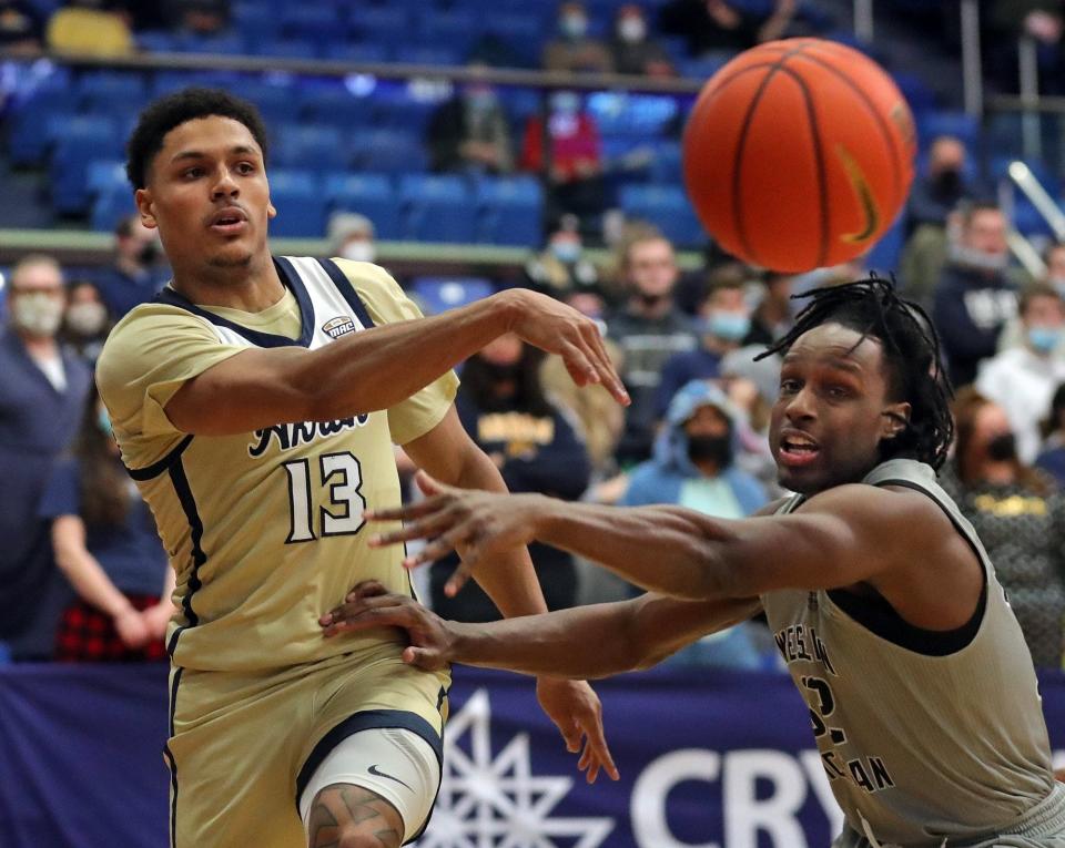 Akron Zips guard Xavier Castaneda (13) makes a pass against Western Michigan Broncos guard Mack Smith (32) during the first half of an NCAA basketball game, Tuesday, Jan. 18, 2022, in Akron, Ohio.