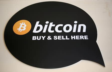 FILE PHOTO: A sign is seen in a restaurant where a Bitcoin ATM is located in Toronto, Ontario, Canada June 3, 2017. REUTERS/Chris Helgren/File Photo