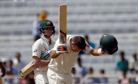 Cricket - India v Australia - Third Test cricket match - Jharkhand State Cricket Association Stadium, Ranchi, India - 17/03/17 - Australia's Glenn Maxwell celebrates his century as his team captain Steven Smith (L) watches. REUTERS/Adnan Abidi