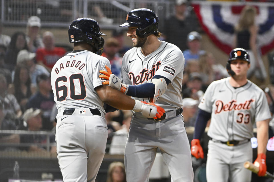 Detroit Tigers' Matt Vierling, right, celebrates with Akil Baddoo (60) after hitting a two-run home run scoring Baddoo against the Minnesota Twins during the ninth inning of a baseball game Wednesday, July 3, 2024, in Minneapolis. The Tigers won 9-2. (AP Photo/Craig Lassig)