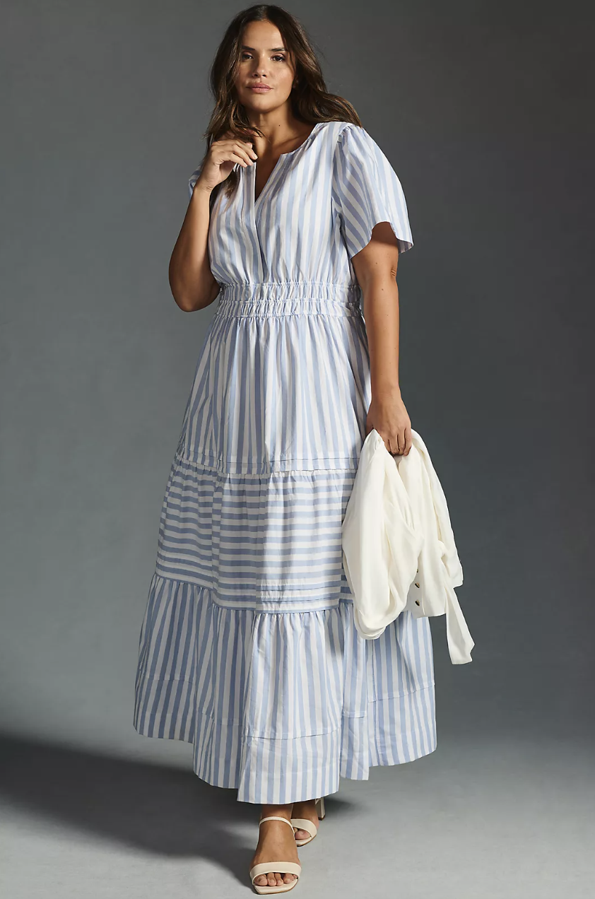 plus size model wearing blue and white striped The Somerset Maxi Dress in sky (photo via Anthropologie)