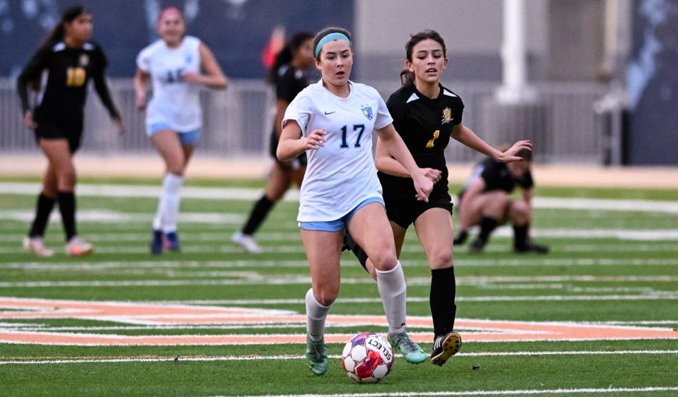 Redwood's Ellie Gilbert charges ahead of Golden West's Crystal Gonzalez in an East Yosemite League girls soccer match Tuesday, February 6, 2024 at College of the Sequoias.
