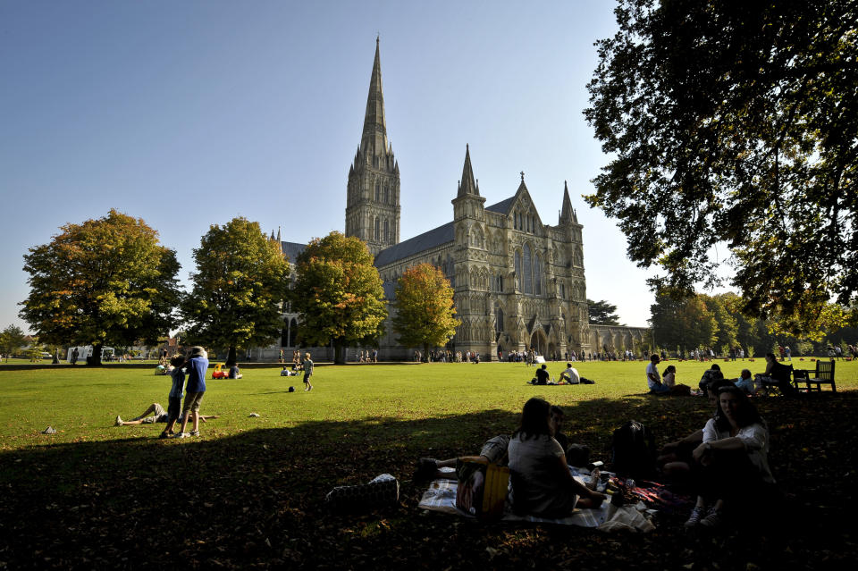 People enjoy the sunshine in Salisbury Cathedral Close, Salisbury, as the heatwave is set to continue well into next week in parts of Britain, following a weekend of record-breaking temperatures.