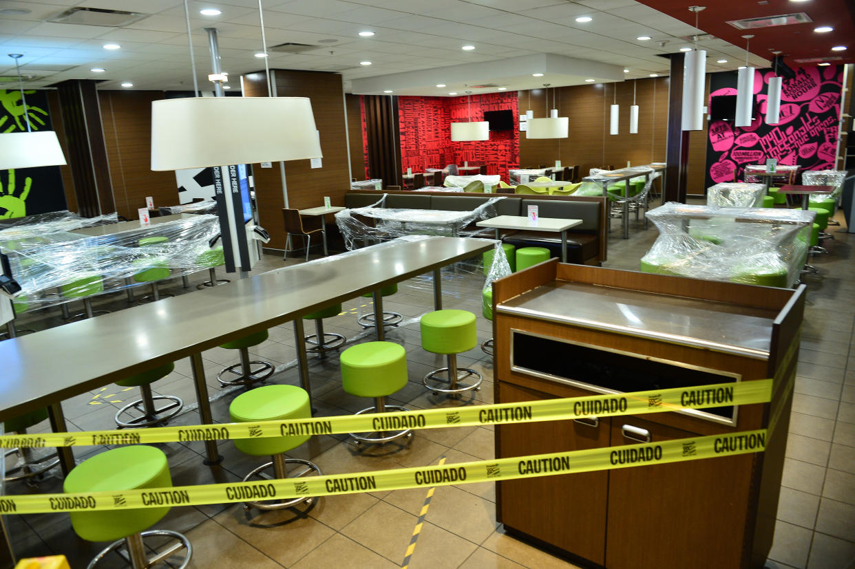 MIAMI BEACH, FLORIDA - JULY 20: A McDonalds closed for indoor dining with tables and chairs wrapped with plastic by order of Miami-Dade County Mayor Carlos Gimenez on July 20, 2020 in Miami Beach, Florida. Miami Dade County imposed a daily 8 p.m. to 6 a.m curfew. The City of Miami Beach put the curfew back into place to fight the spread of the coronavirus (COVID-19), which has spiked in recent days after the Phase 1 reopening of businesses. Florida Gov. Ron DeSantis refused calls to impose a statewide face mask mandate despite the record numbers of coronavirus cases and deaths in the state in recent days. (Photo by Johnny Louis/Getty Images)