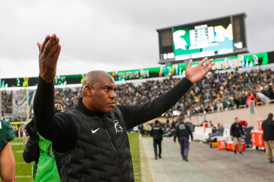 Michigan State head coach Mel Tucker waves at fans to celebrate their 37-33 win over Michigan at Spartan Stadium in East Lansing on Saturday, Oct. 30, 2021.