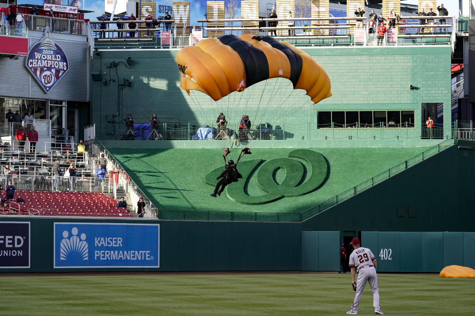 The U.S. Army Parachute Team the Golden Knights descend into National Park before a baseball game between the Washington Nationals and the Arizona Diamondbacks Wednesday, April 20, 2022, in Washington. The U.S. Capitol was briefly evacuated after police said they were tracking an aircraft “that poses a probable threat,” but the plane turned out to be the military aircraft with people parachuting out of it for a demonstration at the Nationals game, officials told The Associated Press. (AP Photo/Alex Brandon)