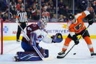 Colorado Avalanche's Justus Annunen, left, and Philadelphia Flyers' Patrick Brown watch a shot during the second period of an NHL hockey game, Monday, Dec. 6, 2021, in Philadelphia. (AP Photo/Matt Slocum)